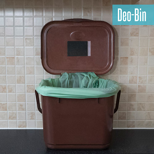 Bin patch stuck to the lid of a small food waste bin.