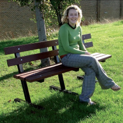 Woman sat on a brown recycled plastic & steel seat.