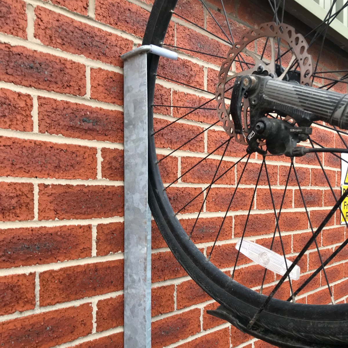 Eltham vertical cycle trough connected to a wall and bike.