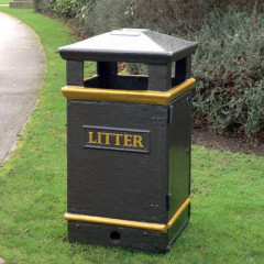 Closed top black GFC litter bin with ash tray on top in an outdoor setting.