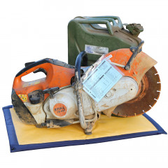 SpillTrapper oil pad under a circular saw and green metal jerry can